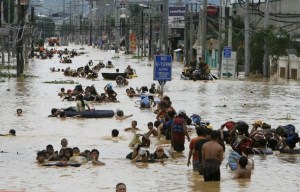 Residents wade in floodwaters caused by Typhoon Ondoy in Cainta Rizal east of Manila September 27, 2009 (photo from Reuters)