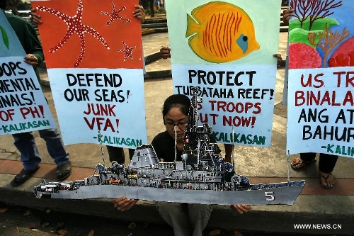 Environmental advocates and activists protest the grounding of the USS Guardian on Tubbataha Reef, call for the junking of the Visiting Forces Agreement (VFA) and immediate pullout of US troops from the Philippines. (Photo from www.globaltimes.cn)